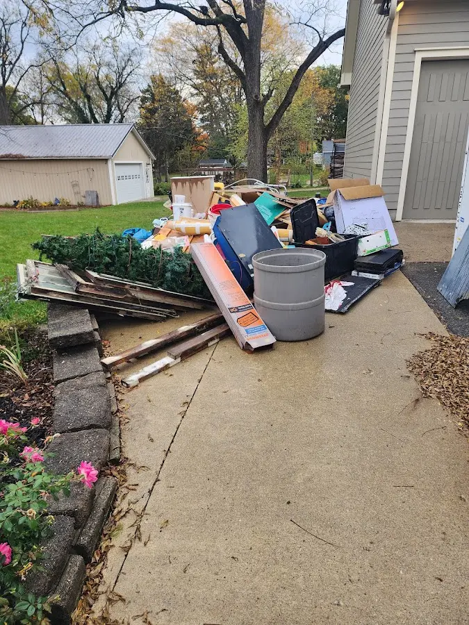 Dumpster being loaded with debris for Estate Cleanout Dumpster Rental in Donaldsonville